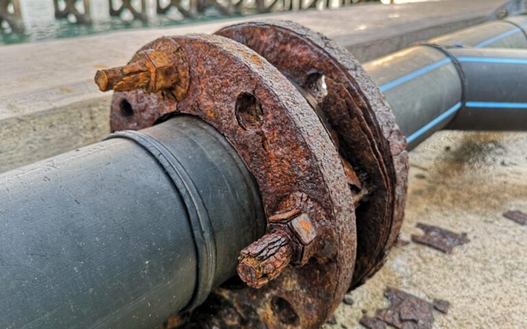 Rusted flange and bolts on an industrial pipe